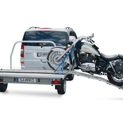 Motorcycle on a trailer attached to a towbar
