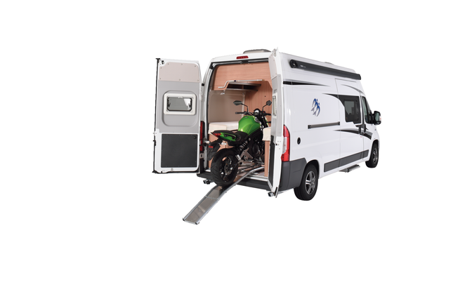 Motorhome with open door revealing a motorcycle loading inside 